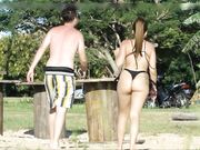 Woman with a great big thick ass wearing thong is filmed at the beach